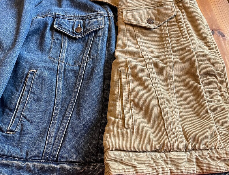 Op de afbeelding: Een spijkerjack met een corduroy jack dat aan de rechterkant is genaaid. Het spijkerjack is blauw en het corduroy jack is bruin.