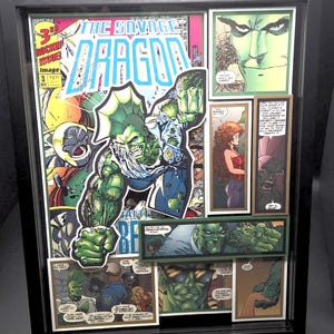 May include: Framed comic book art featuring the title "The Savage Dragon" with a green-skinned superhero. The artwork includes various comic panels and the cover of issue #3, with vibrant colors and dynamic illustrations. The frame is black.