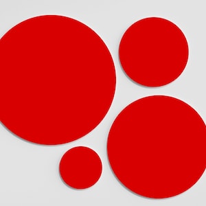 May include: Four red circles of varying sizes on a white background. The largest circle is in the top left corner, the second largest is in the bottom right corner, the third largest is in the top right corner, and the smallest circle is in the bottom left corner.