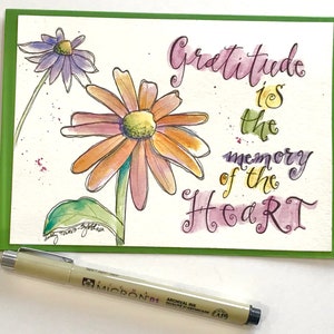 May include: A watercolor painting of two flowers with the quote "Gratitude is the memory of the heart" written in cursive.