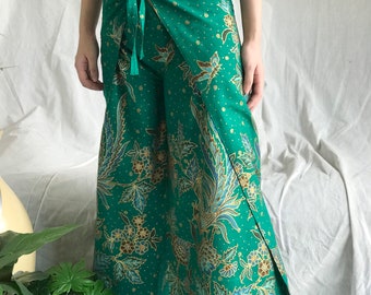 May include: Green wrap pants with a floral print and a tie at the waist.