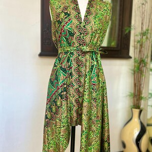 May include: A green and gold patterned sleeveless dress with a V-neckline and a tie at the waist.