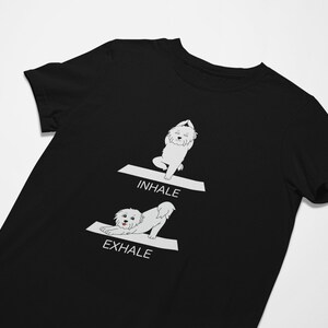 May include: Black t-shirt with a white illustration of a dog doing yoga poses. The text "INHALE" and "EXHALE" are printed on the shirt.