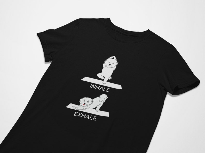 May include: Black t-shirt with a white illustration of a dog doing yoga poses. The text "INHALE" and "EXHALE" are printed on the shirt.