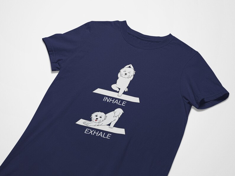 May include: A navy blue t-shirt with a white graphic of a dog doing yoga poses. The text "INHALE" and "EXHALE" are printed on the shirt.