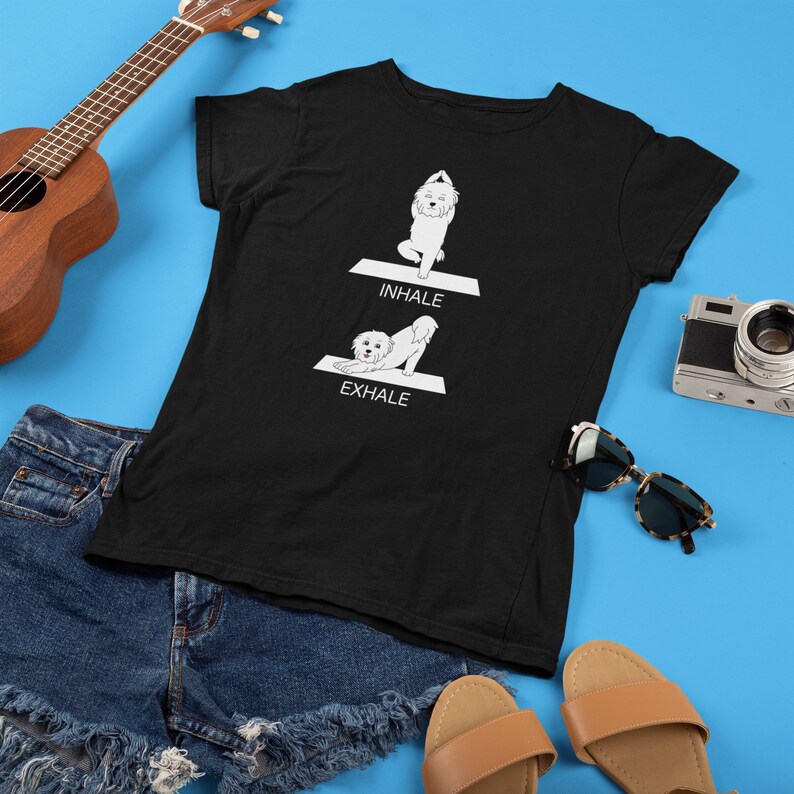 May include: Black t-shirt with a white dog doing yoga poses. The text "INHALE" and "EXHALE" are printed on the shirt.