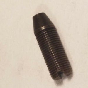 May include: A black metal screw with a slotted head and a threaded shaft.