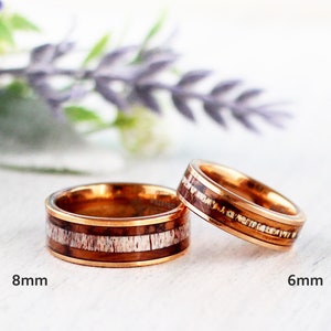 May include: Two gold-toned rings with a wood inlay. The ring on the left is 8mm wide and the ring on the right is 6mm wide.