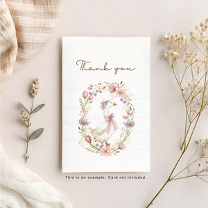 May include: A white thank you card with a floral wreath and a goose wearing a flower crown. The text "Thank you" is printed in brown lettering.