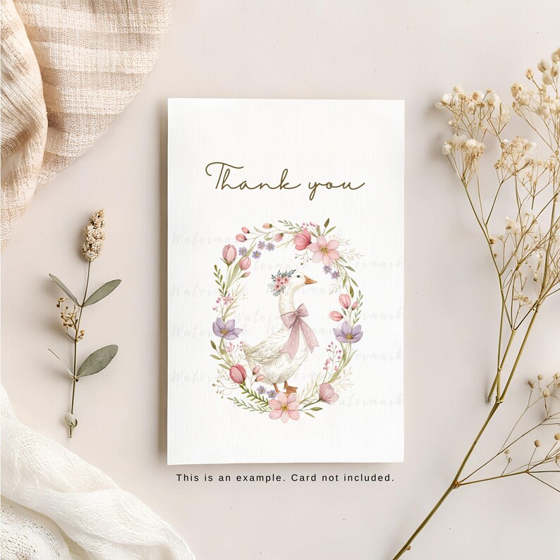 May include: A white thank you card with a floral wreath and a goose wearing a flower crown. The text "Thank you" is printed in brown lettering.