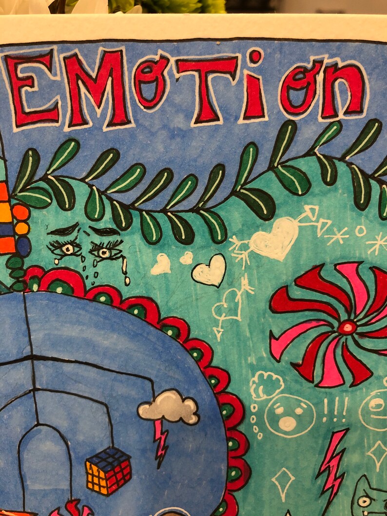 May include: A colorful drawing with the word "EMOTION" in red letters at the top. The drawing includes a blue sky with white clouds, a red and green flower, a red and pink pinwheel, and a white heart.