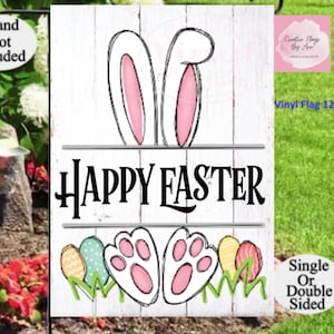 May include: White wooden sign with a bunny rabbit design and the text "HAPPY EASTER". The sign is decorated with pink bunny ears, paw prints, and colorful Easter eggs. The sign is 12x16 inches.