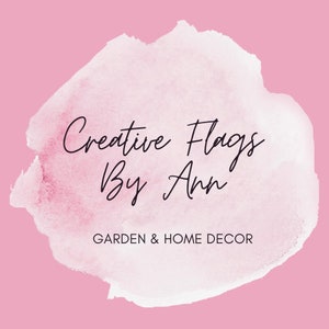 May include: A watercolor-style logo with a pink background and white text. The text reads "Creative Flags By Ann" and "GARDEN & HOME DECOR".