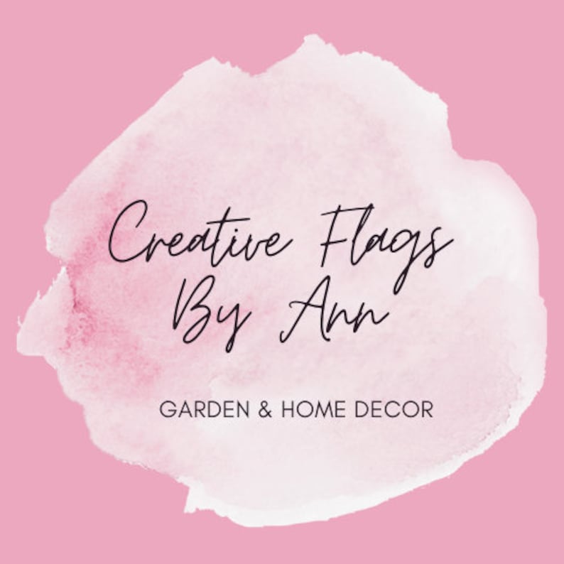 May include: A watercolor-style logo with a pink background and white text. The text reads "Creative Flags By Ann" and "GARDEN & HOME DECOR".