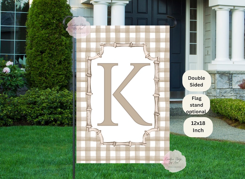May include: A double-sided garden flag with a tan and white gingham pattern. The flag features a large letter "K" in a light brown color, framed by a bamboo-style border. The flag measures 12x18 inches.