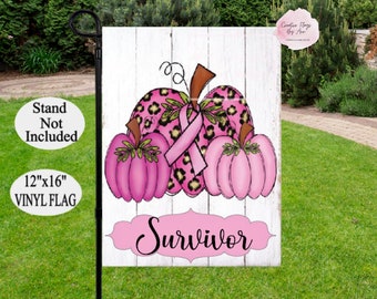 May include: A 30cm x 41cm vinyl garden flag with pink pumpkins, leopard print, and a pink ribbon. The word "Survivor" is displayed on a pink banner. The flag is designed for outdoor use.