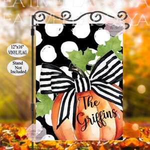 May include: A 12x16 inch black and white polka dot garden flag with a large orange pumpkin with a black and white striped bow. The pumpkin has the text "The Griffins" written on it.