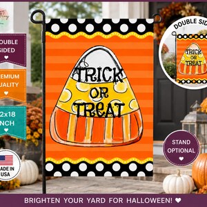 May include: A rectangular garden flag featuring a central candy corn illustration with the text "TRICK OR TREAT" in black. The background has horizontal orange stripes, bordered by black and white polka dots. The flag measures 12x18 inches.