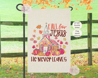 May include: A double-sided 12"x18" garden flag with a fall theme. The flag features a church, pumpkins, and autumn leaves. Text reads "FALL for JESUS" and "He Never LEAVES". A flag stand is optional.