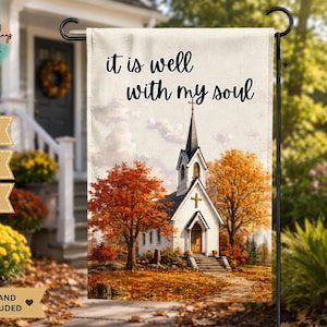May include: A rectangular garden flag featuring a white church with a steeple and a cross, surrounded by autumn trees with orange and yellow leaves. The text "it is well with my soul" is printed in black script at the top. The flag measures 12x18 inches.