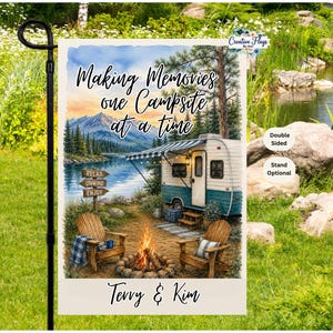 May include: A rectangular garden flag featuring a watercolor illustration of a campsite with a teal and white camper, a campfire, two wooden chairs, and a lake with mountains in the background. The text reads "Making Memories one Campsite at a time" and "Terry & Kim".