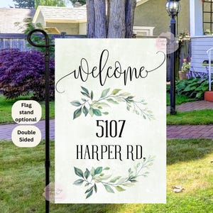 May include: A welcome sign with a white background and green watercolor leaves. The sign says "Welcome" in cursive and "5107 Harper Rd."