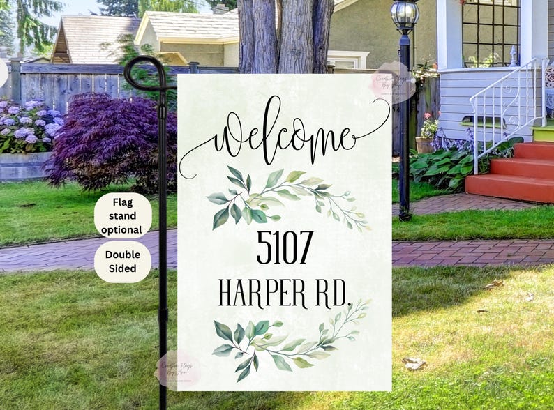 May include: A welcome sign with a white background and green watercolor leaves. The sign says "Welcome" in cursive and "5107 Harper Rd."