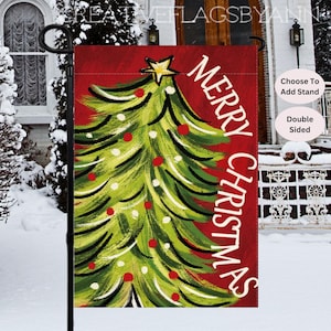 May include: A double-sided Christmas garden flag with a festive design. The flag features a green Christmas tree with red ornaments and a gold star on a red background. The words "MERRY CHRISTMAS" are written vertically in white.