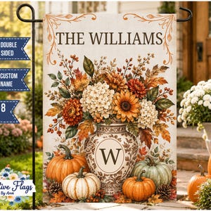 May include: A rectangular garden flag featuring the text THE WILLIAMS above a floral arrangement in a vase with the letter W. The design includes orange, yellow, and white flowers, autumn leaves, and pumpkins at the base, measuring 12x18 inches.