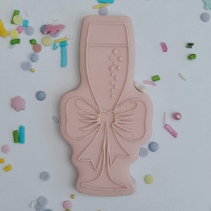 Champagne glass with a bow embosser acrylic fondant stamp and matching cutter combo