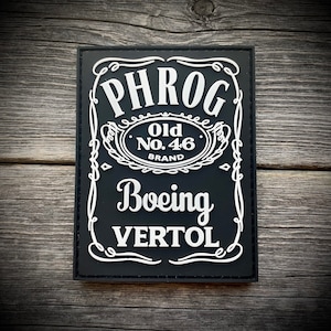 May include: Black and white patch with the text "PHROG Old No. 46 Brand Boeing Vertol" in a stylized font.