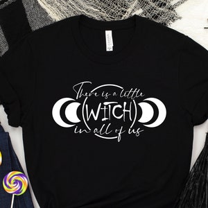 May include: Black t-shirt with white text that reads "There is a little (WITCH) in all of us" with a crescent moon graphic on each side of the text.