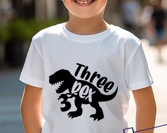 May include: White t-shirt with a black dinosaur graphic and the text "Three Rex" with the number "3" in the dinosaur's mouth.