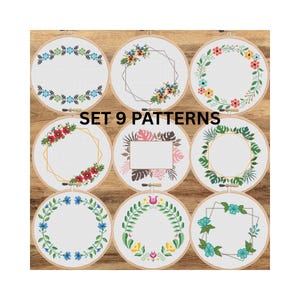 May include: Set of 9 embroidery patterns featuring floral wreaths and geometric frames in various colors. The patterns are displayed in round wooden hoops.