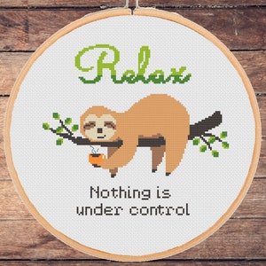 May include: Cross-stitch embroidery hoop with a sloth holding a cup of coffee and the text "Relax, Nothing is under control".