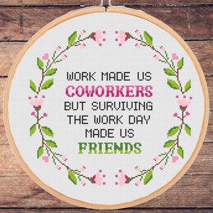 May include: White embroidery hoop with a floral wreath design and the text "Work made us coworkers but surviving the work day made us friends".