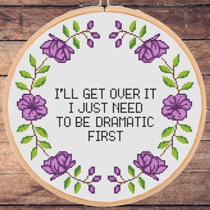 Puede incluir: Un aro de bordado blanco con un borde floral morado y el texto "I'll get over it. I just need to be dramatic first."