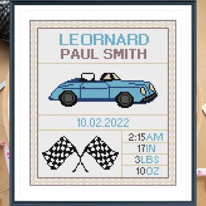 May include: A blue and white cross-stitch pattern with a blue car, checkered flags, and the text "LEONARD PAUL SMITH 10.02.2022 2:15 AM 17 IN 3 LBS 10 OZ".