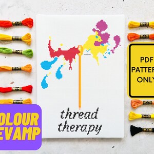 May include: A cross-stitch pattern for a colorful paint splatter design with the text "thread therapy". The pattern is available as a PDF download. The image also shows a variety of embroidery floss in different colors.