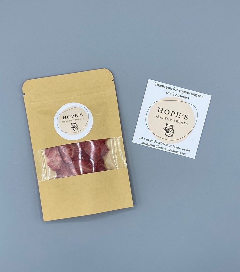May include: A kraft paper bag with a clear window containing dried, reddish-brown treats. The bag has a circular label with the text "HOPE'S HEALTHY TREATS" and a small illustration. A card next to the bag reads "Thank you for supporting my small business."