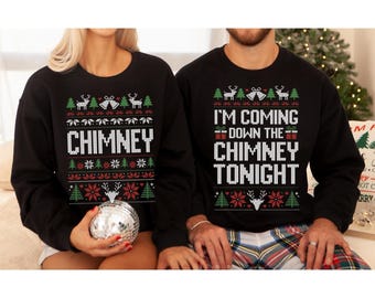 May include: Black Christmas sweaters with festive designs. One sweater says "CHIMNEY" in white, the other says "I'M COMING DOWN THE CHIMNEY TONIGHT". Both have reindeer, trees, and bell patterns.