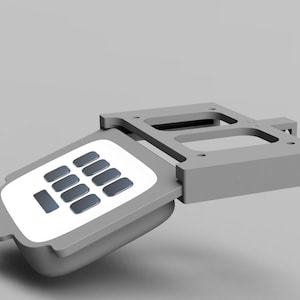 May include: A gray plastic keypad with a white face and 12 buttons. The keypad is attached to a gray plastic frame.