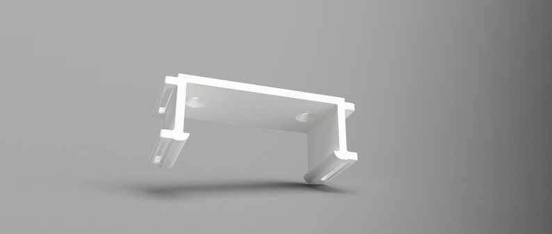 May include: White plastic bracket with two slots on each side and two holes on the top. The bracket is designed to hold a curtain rod.