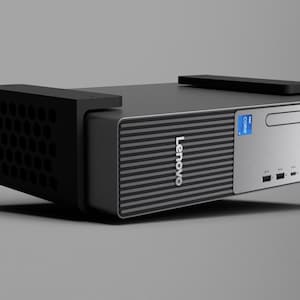 May include: A Lenovo ThinkCentre desktop computer in a compact form factor. The front panel is silver with a black ribbed section, featuring the Lenovo logo, an Intel Core sticker, a disc drive slot, USB ports, audio jacks, and a power button.