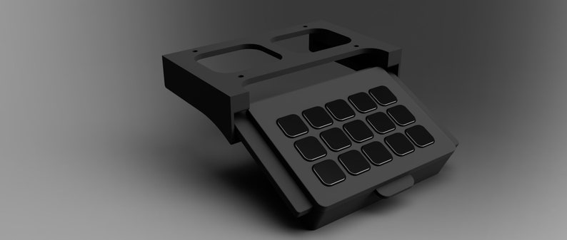 May include: A black, rectangular, keyboard-like device with a hinged lid. The lid is open, revealing a grid of 16 black buttons.