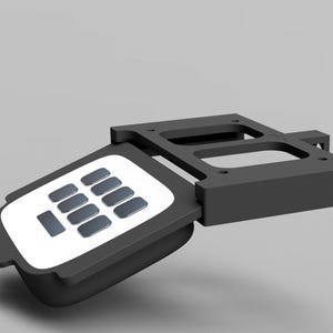 May include: A black and white keypad with a white background and black buttons. The keypad is attached to a black metal frame.