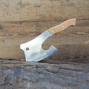 May include: A handcrafted cleaver with a polished steel blade and a light-colored wooden handle. The handle is secured with three rivets. The cleaver is designed with a curved blade and a hole near the top.