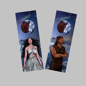 May include: Two fantasy bookmarks. One shows a woman in a white dress, the other a man in a brown vest, both against a snowy mountain backdrop. Each bookmark has a celestial design with a red and white sphere.