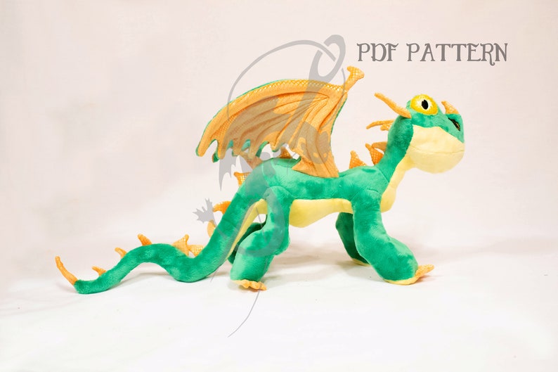 May include: A green and yellow plush dragon with orange wings. The dragon is standing on all fours and has a long tail. The dragon is a popular character from the animated movie How to Train Your Dragon.