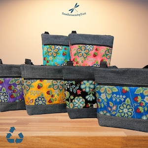 May include: Six denim tote bags with different floral fabric panels. The bags have a zipper closure and a top handle. The fabric panels feature a variety of floral patterns and colors, including blue, pink, yellow, and black. The text "SewEsteembyTori" is visible in the top center of the image.